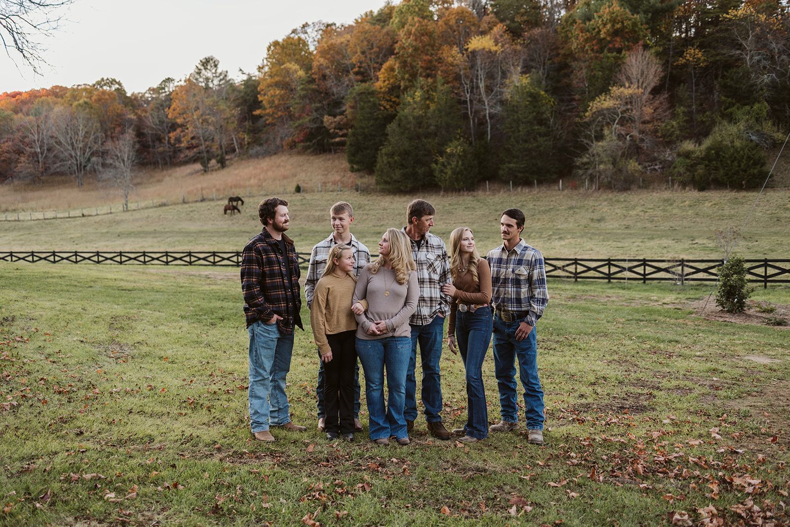 A group of people are standing in a field.