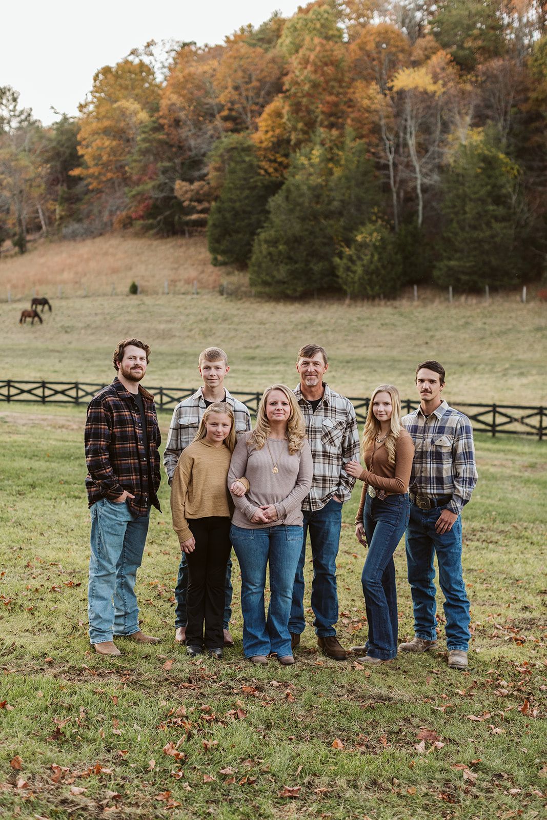 A group of people are posing for a picture in a field.