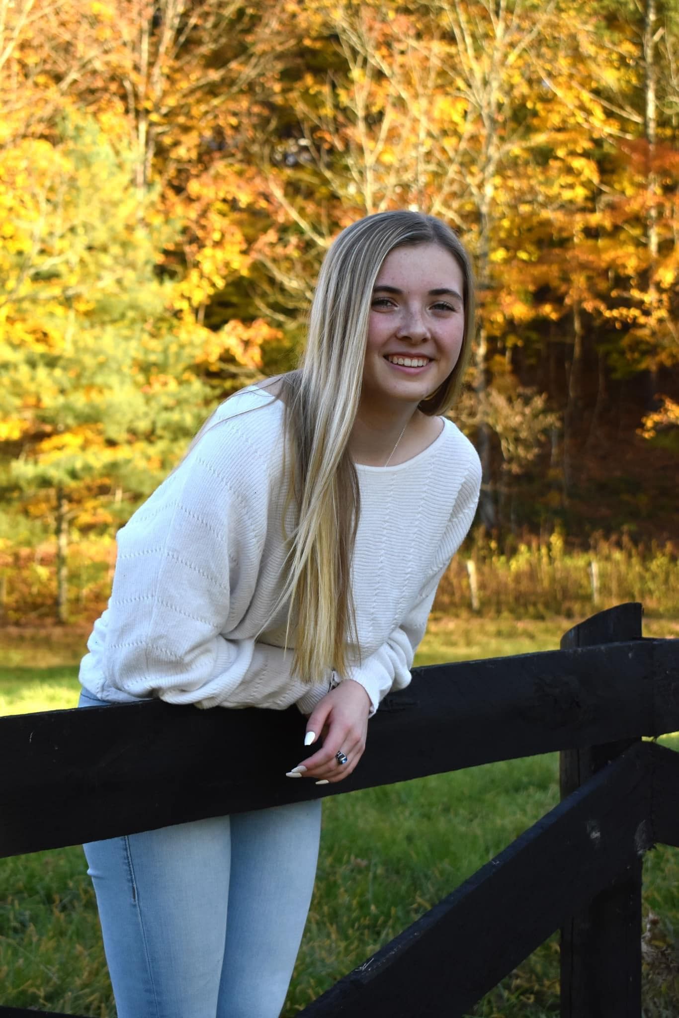 A girl wearing white sleeve smiling in
