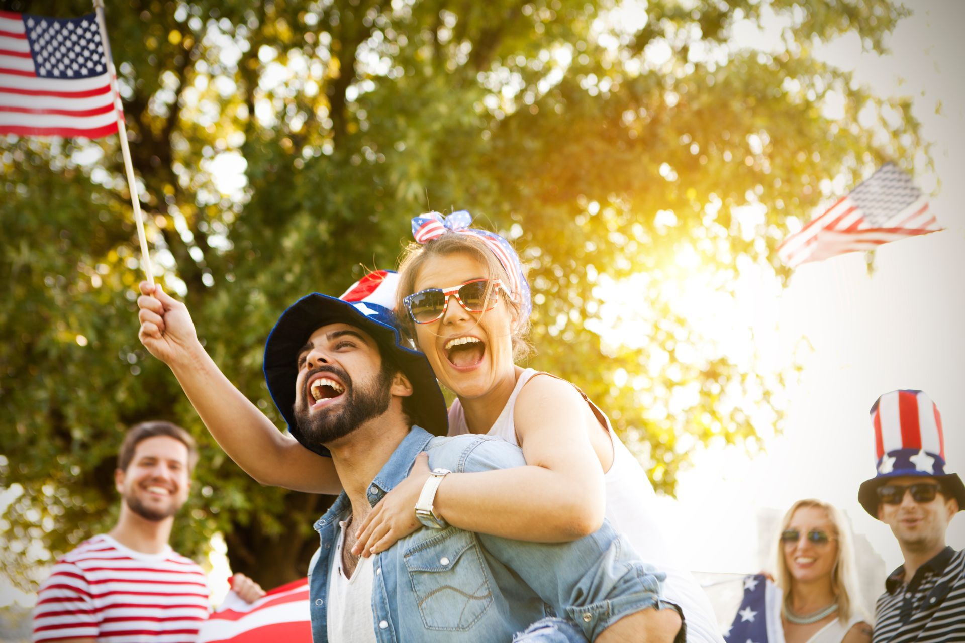 A man is carrying a woman on his back at a parade.
