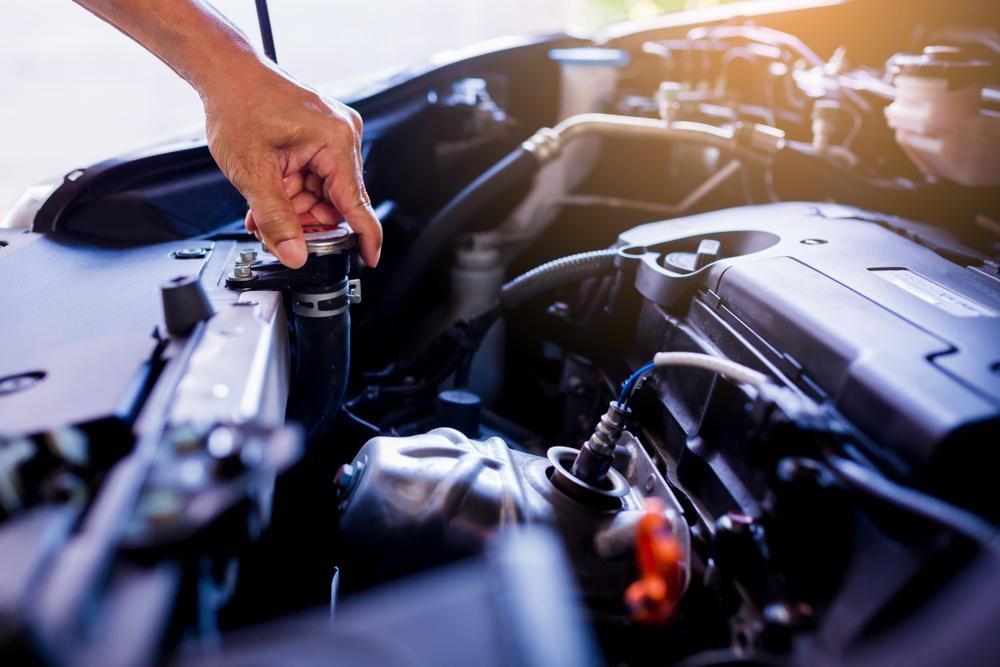 A Person Is Opening the Hood of A Car — Lismore Car Repairs in Lismore, NSW