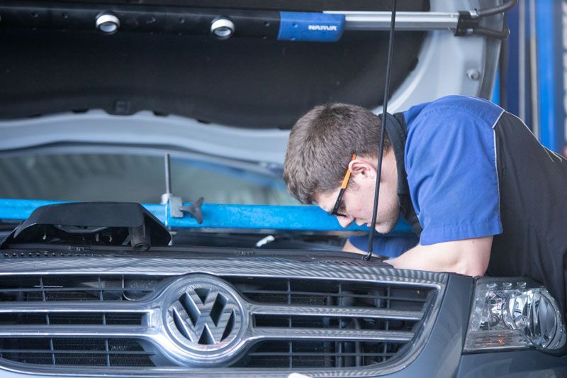 A Man Is Working on The Engine of A Volkswagen Van — Lismore Car Repairs in Lismore, NSW