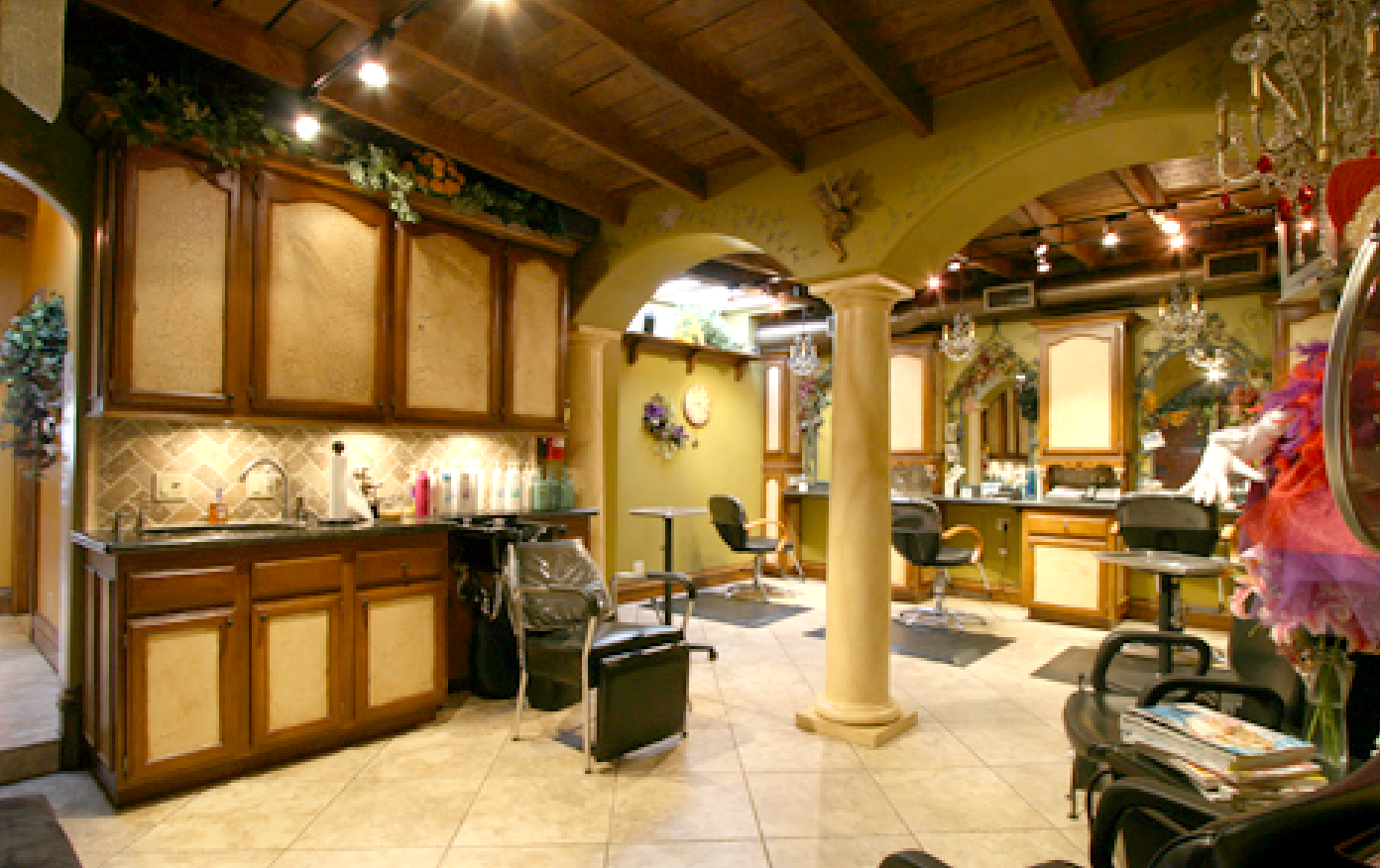 A salon with a sink and chairs in it