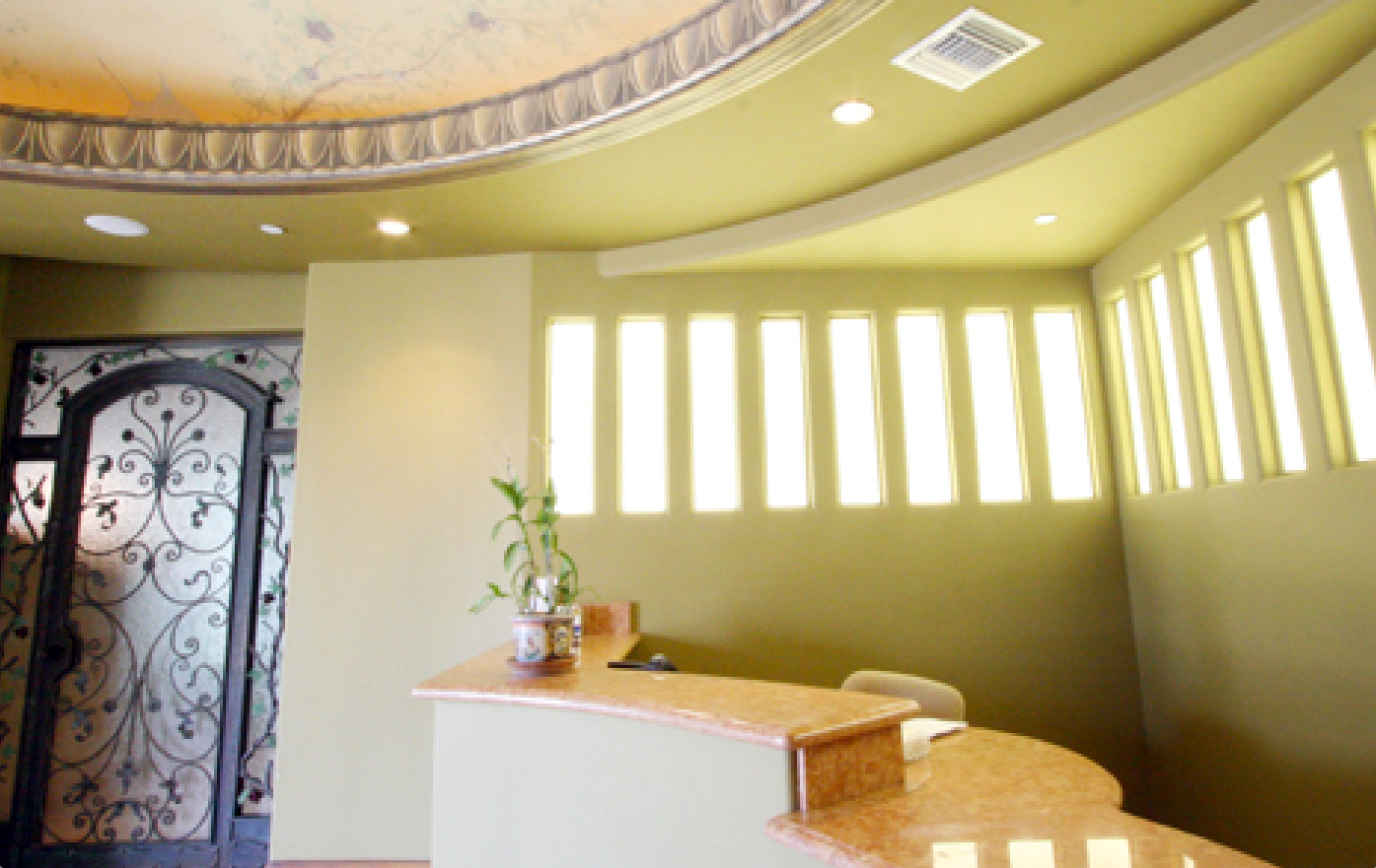 A reception area with a curved ceiling and a marble counter top