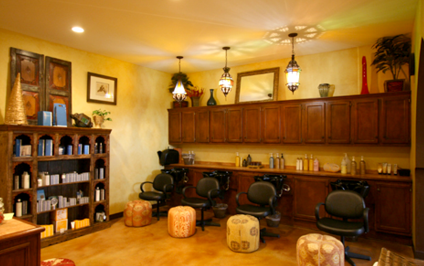 A room with a lot of chairs and ottomans in it