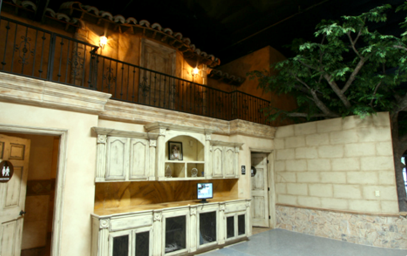 A room with a balcony and a desk with a computer on it