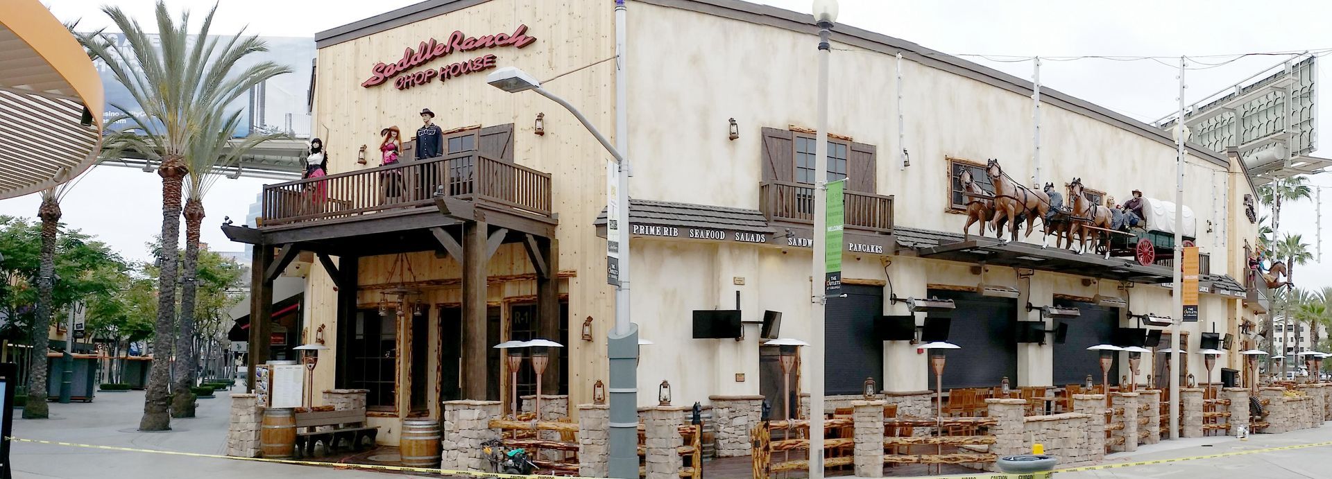 A large white building with a balcony on the side of it.