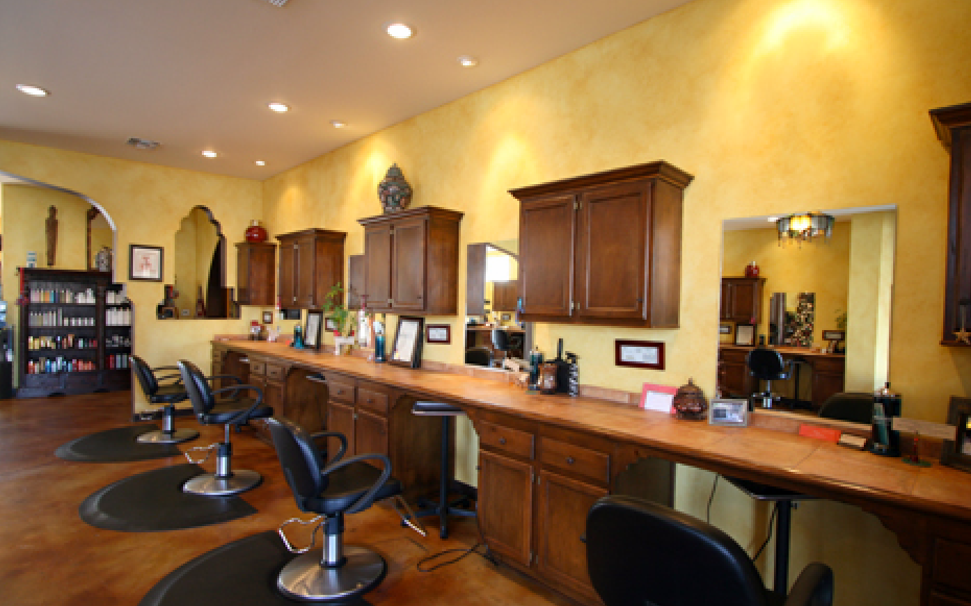 A hair salon with a lot of chairs and tables