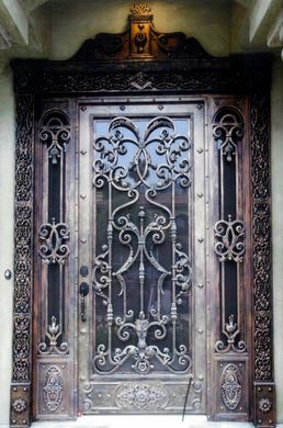 A wrought iron door with a crown on top of it