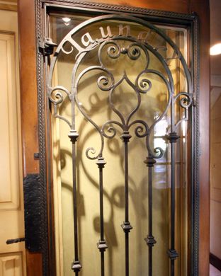 A wrought iron gate with the name claude on it