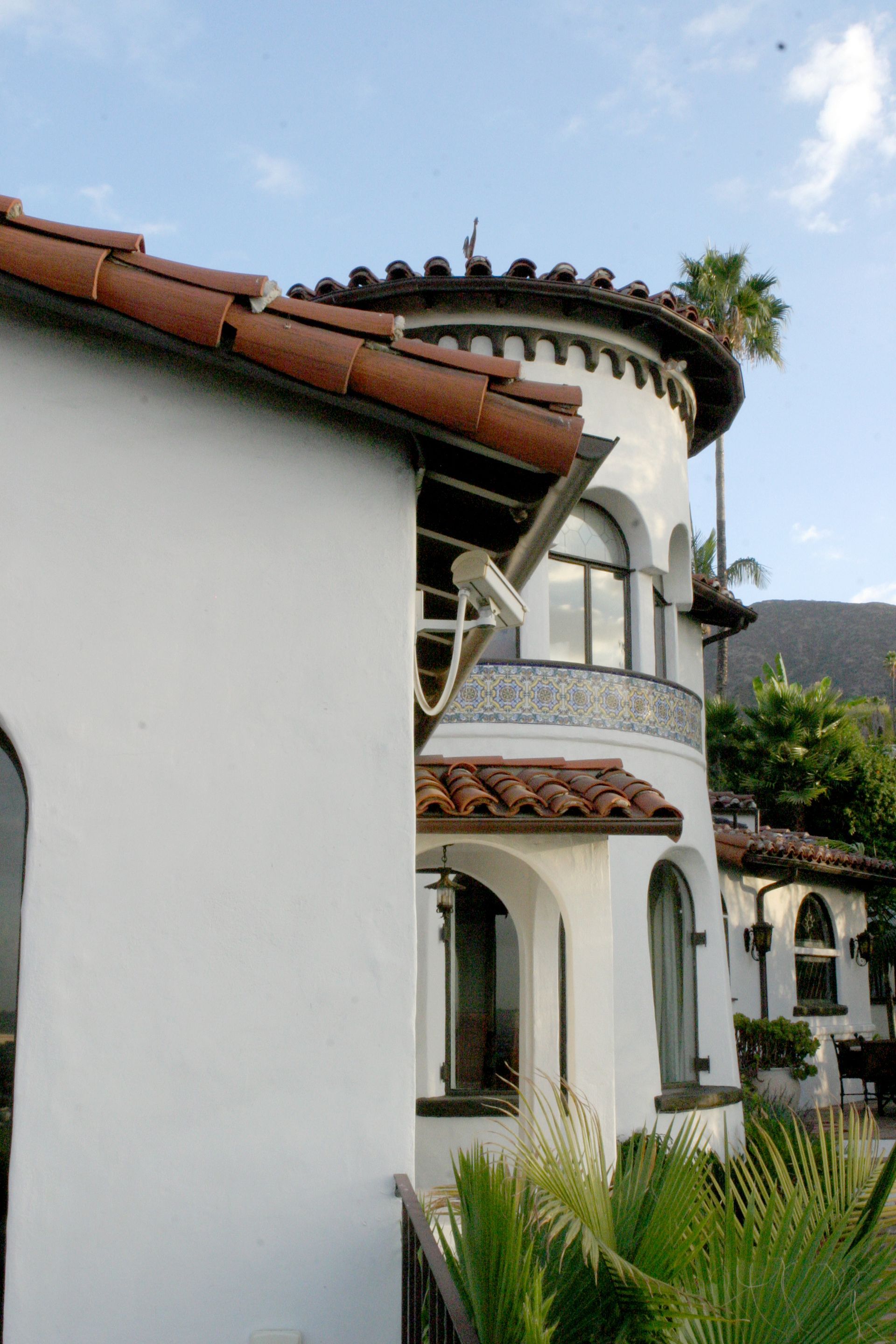 A large white building with a red tile roof