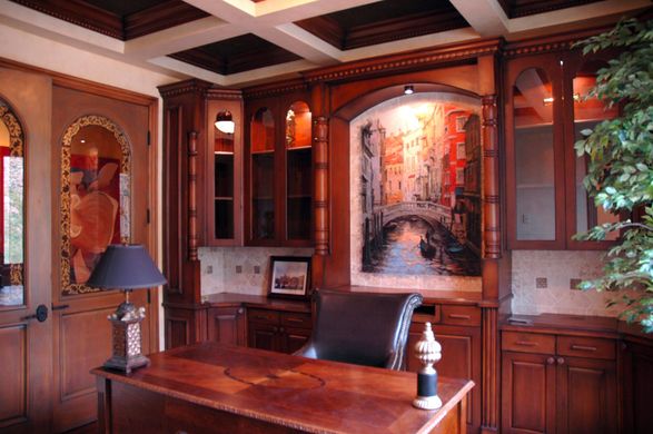 A wooden desk in a room with a painting on the wall