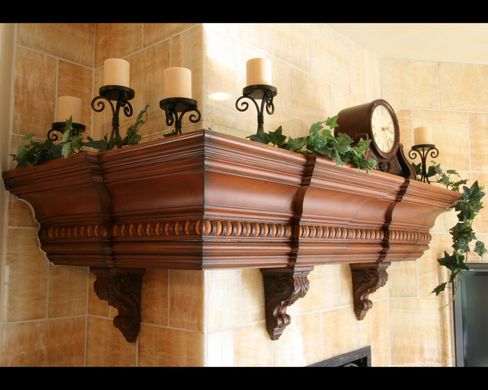 A mantle with candles and a clock on it