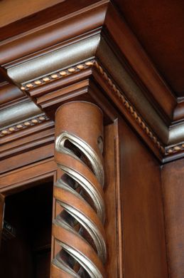 A close up of a wooden pillar with a gold trim