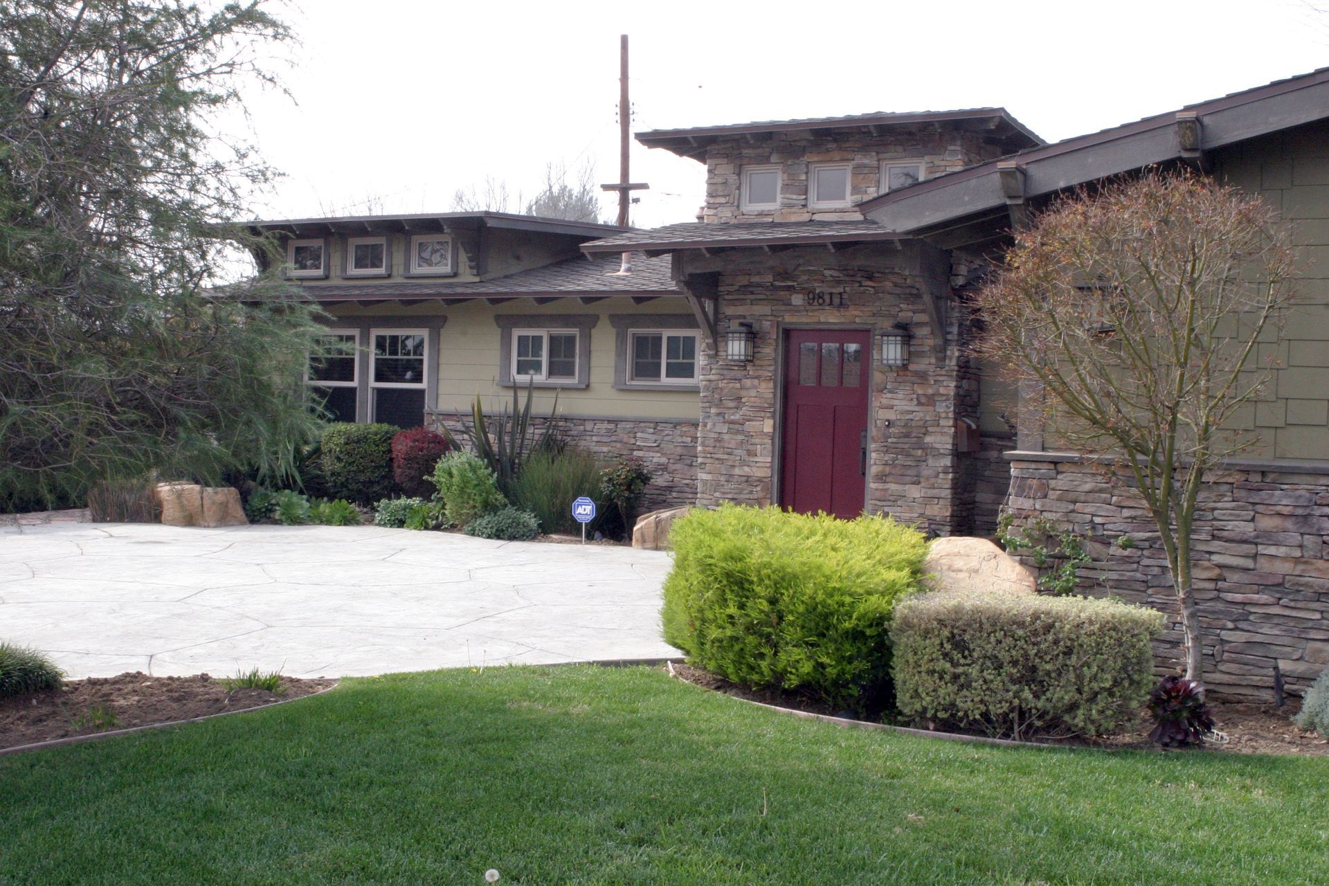 A large house with a red door and a driveway