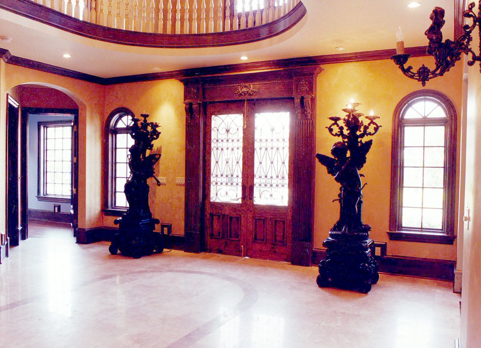 An empty hallway with a statue of an angel in the middle