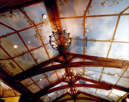 A chandelier hangs from the ceiling of a building