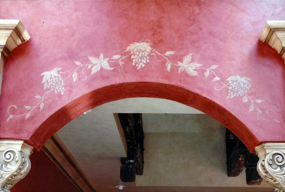 A red archway with white flowers painted on it