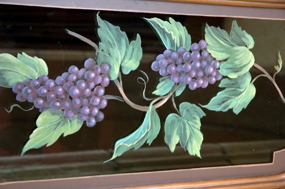 A painting of grapes on a vine with green leaves