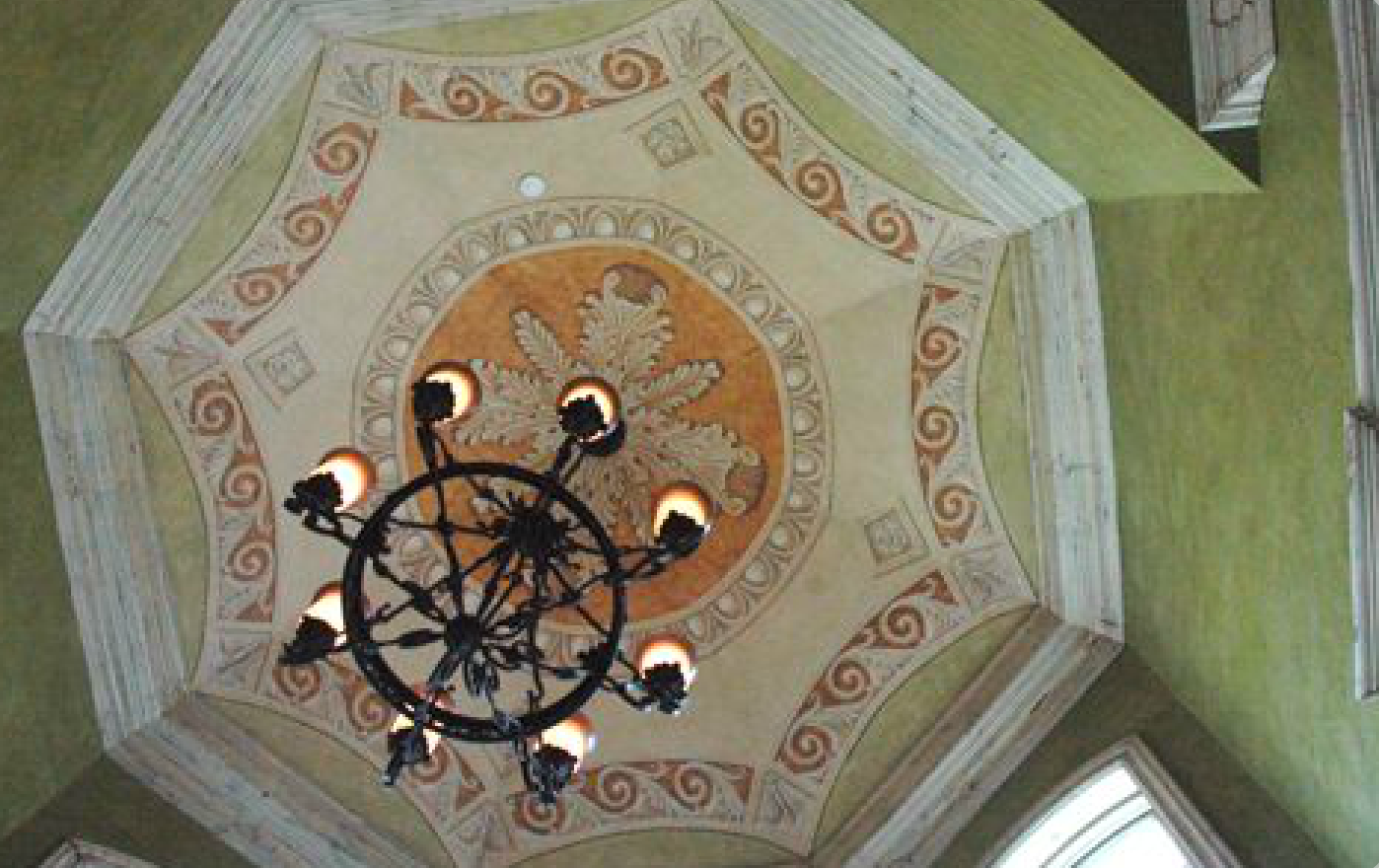 A chandelier is hanging from the ceiling of a building