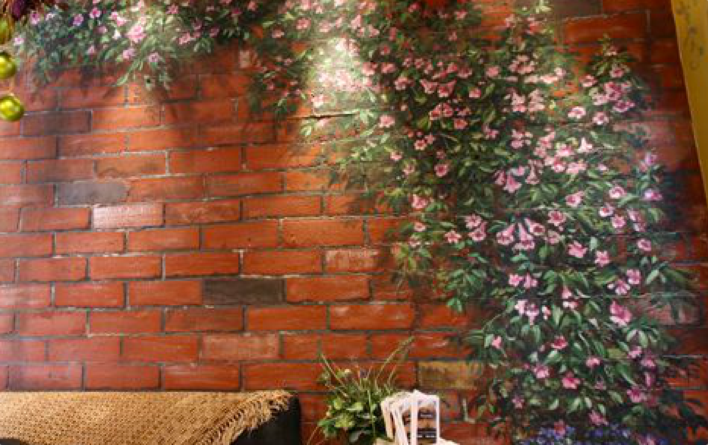 A brick wall with a painting of flowers on it.