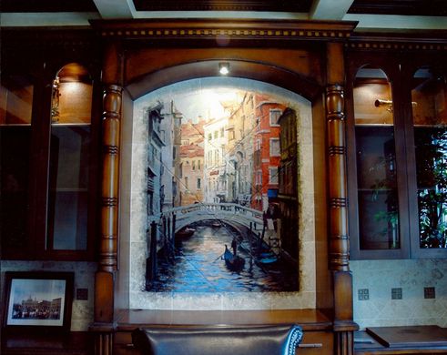 A painting of a canal in venice hangs on a wall