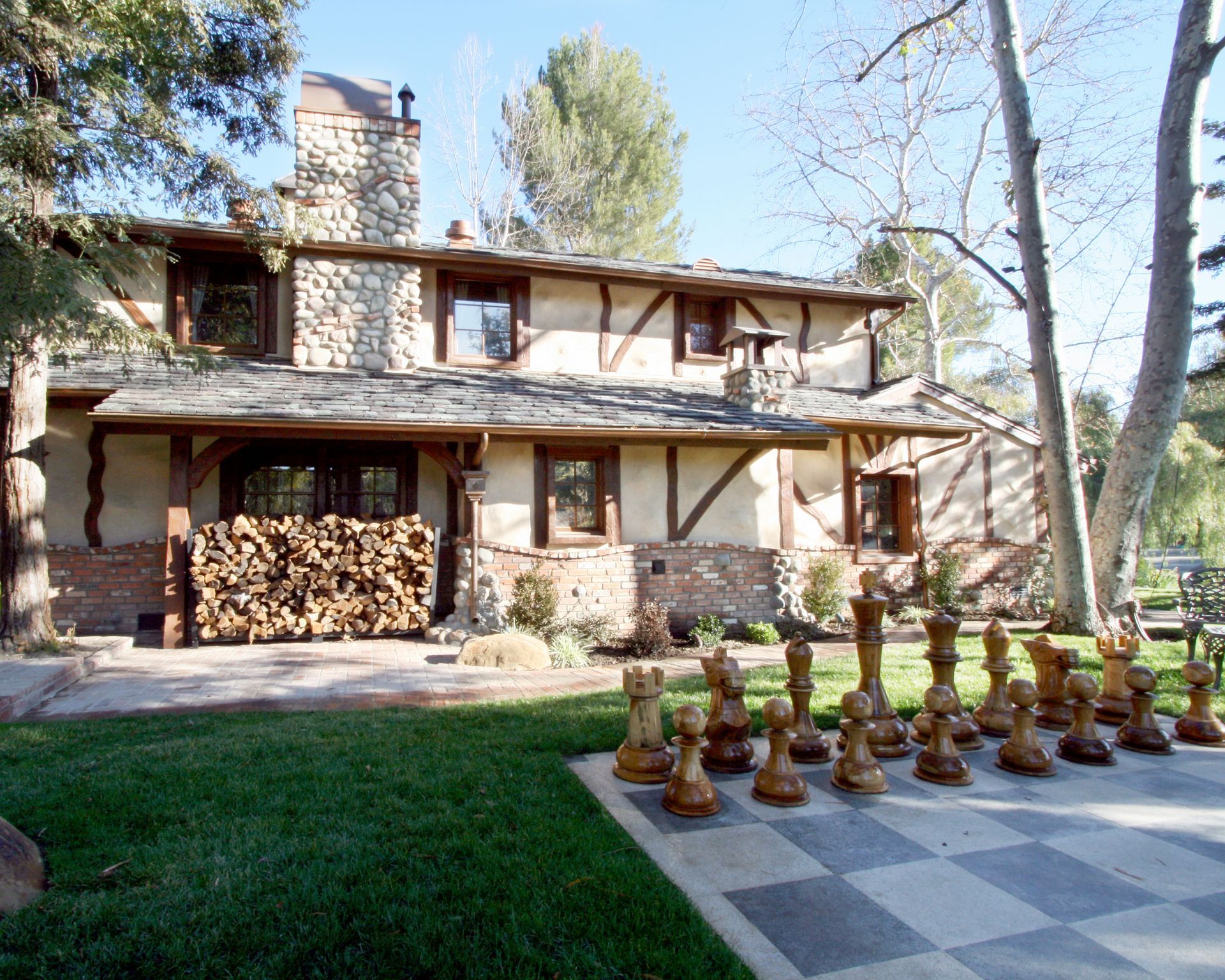 A large chess board in front of a house