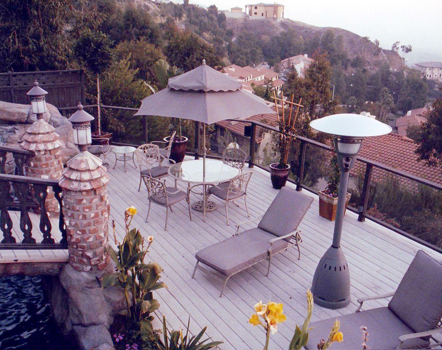A deck with a table and chairs and a heater