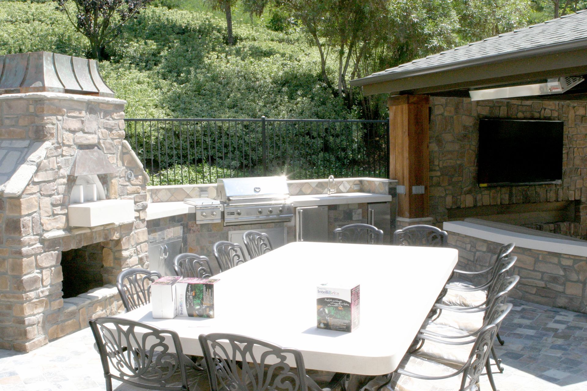 A patio with a table and chairs and a fireplace