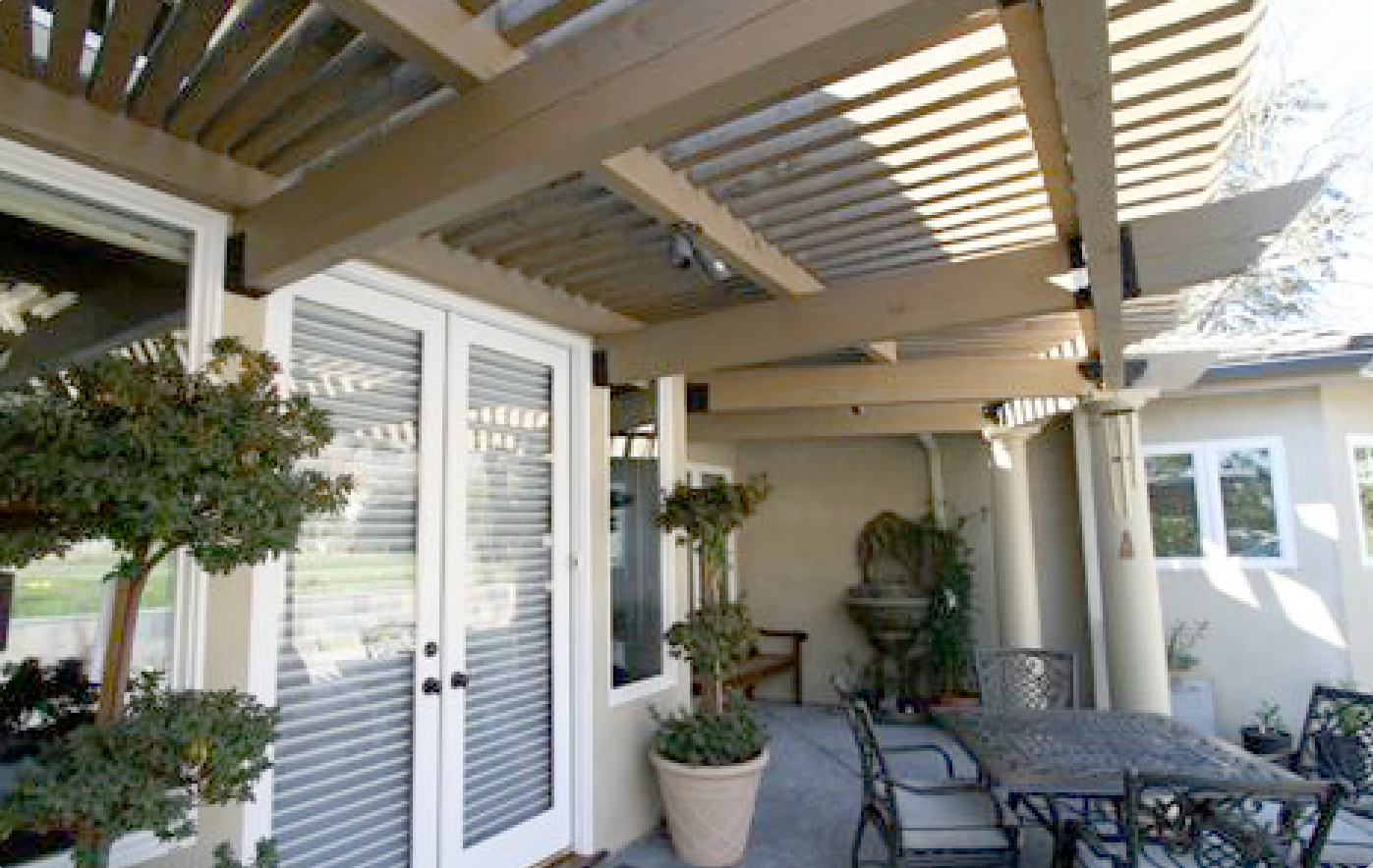 A patio with a table and chairs under a pergola
