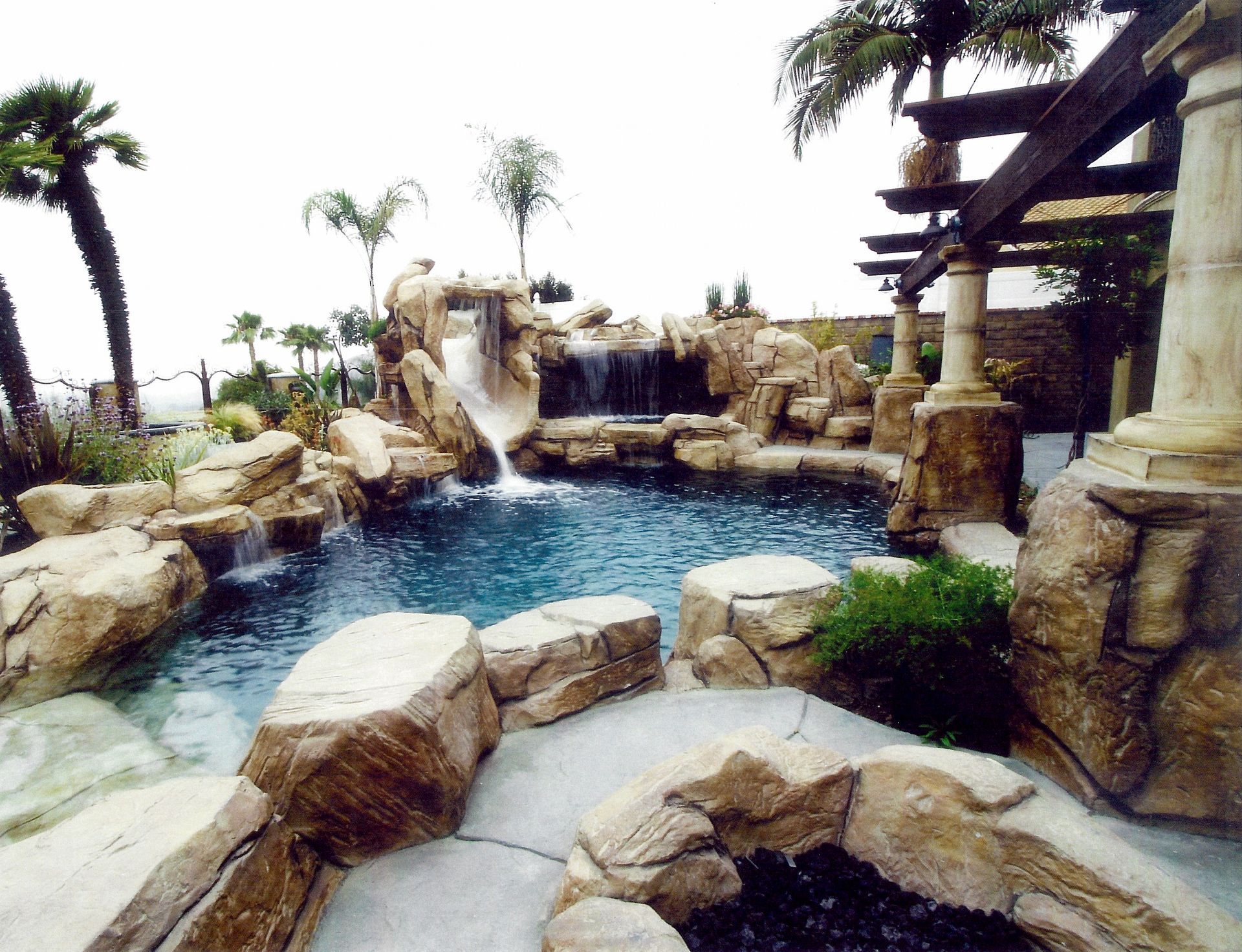 A swimming pool with a waterfall in the background