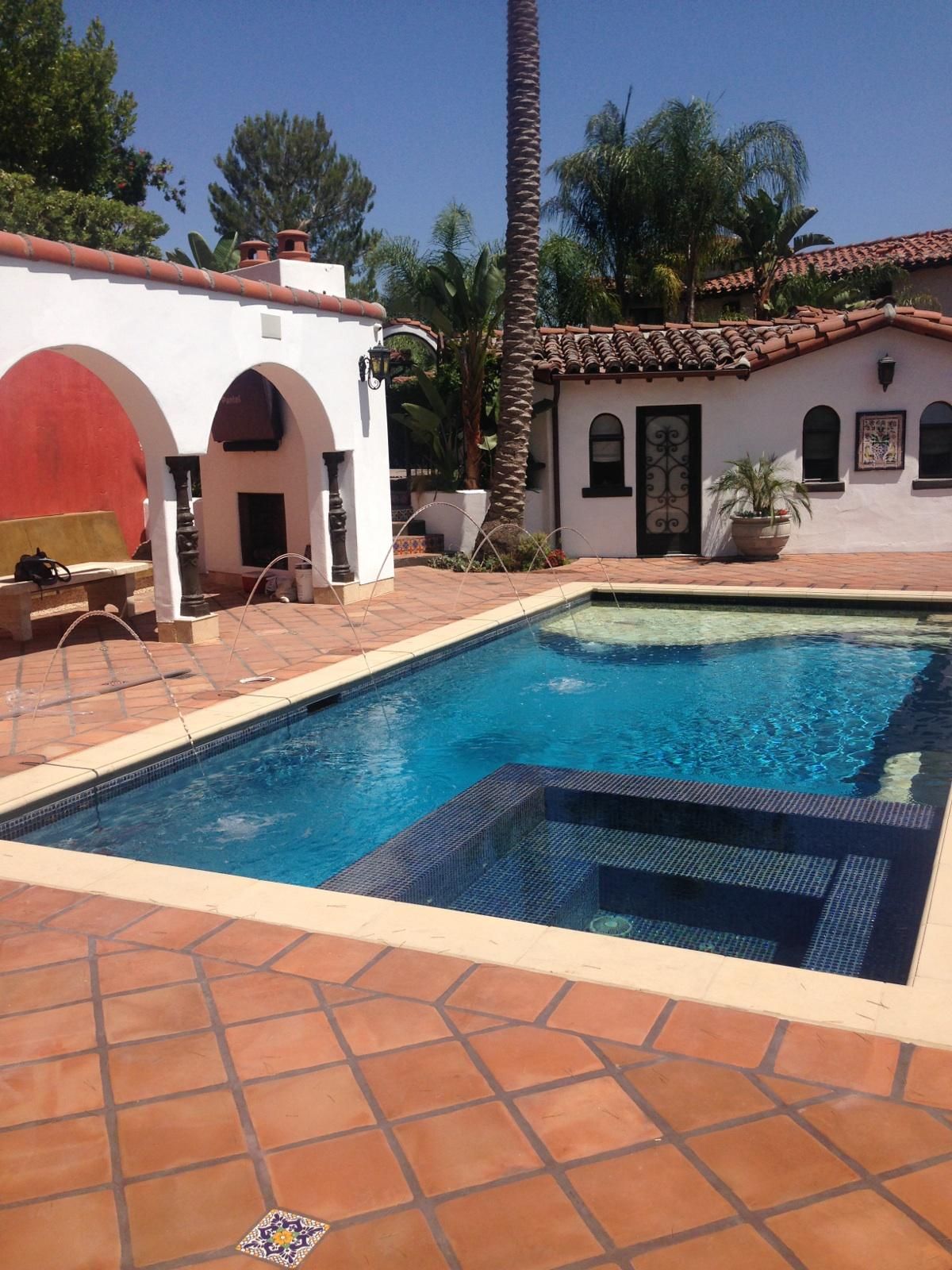 A large swimming pool in front of a white building