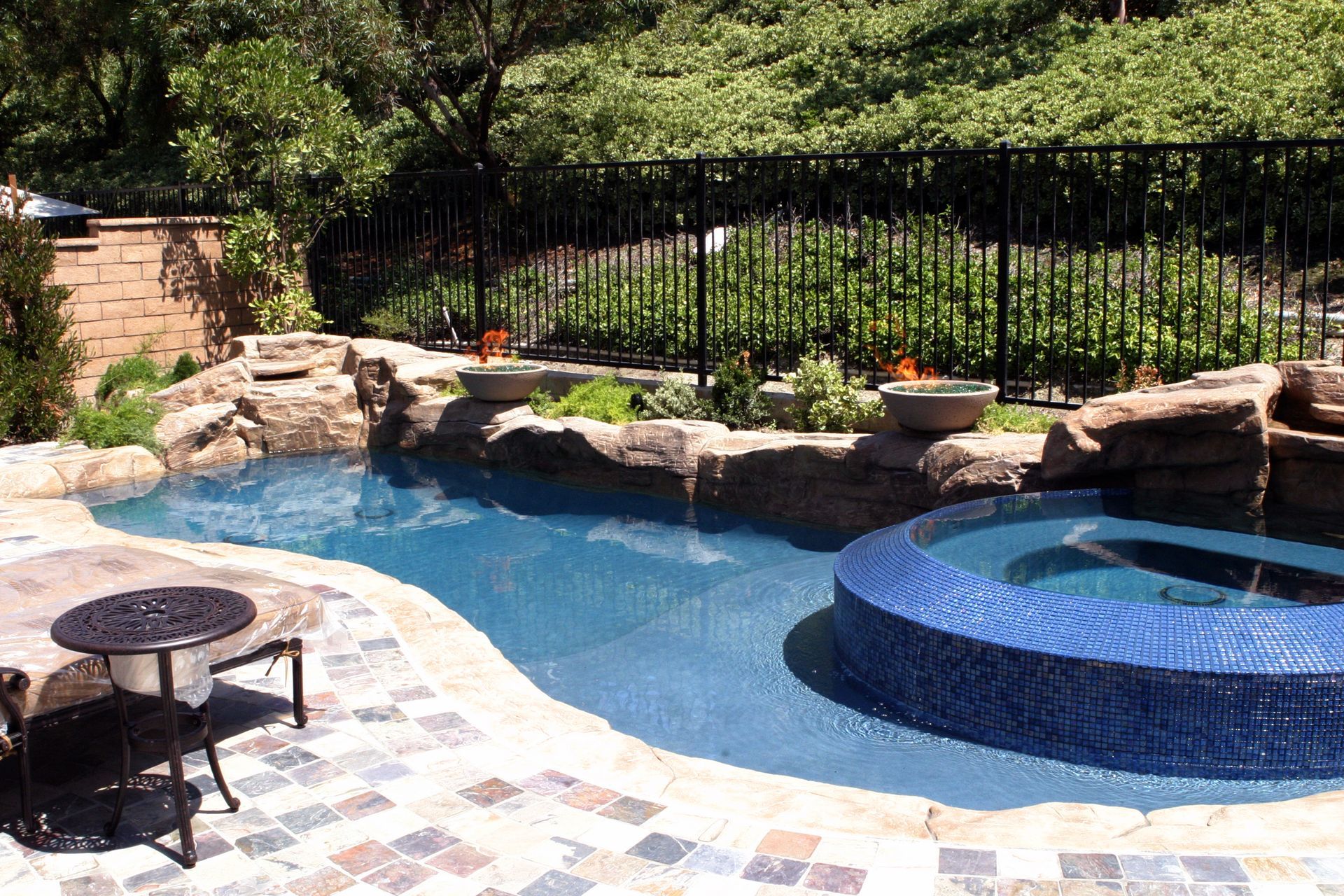 A large swimming pool with a hot tub in the middle