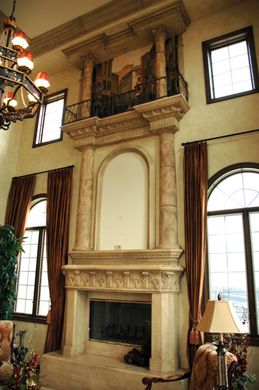 A living room with a fireplace and a chandelier