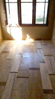 A room with a wooden floor and a window.