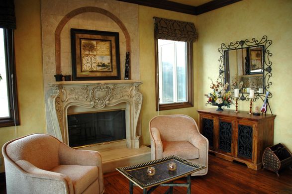 A living room with two chairs and a fireplace