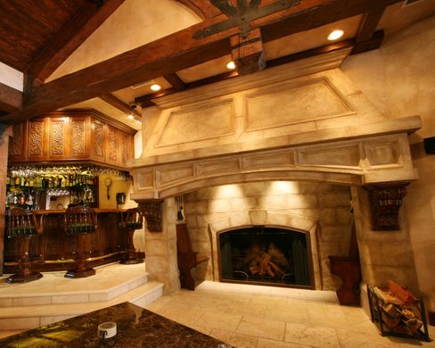 A living room with a fireplace and a bar