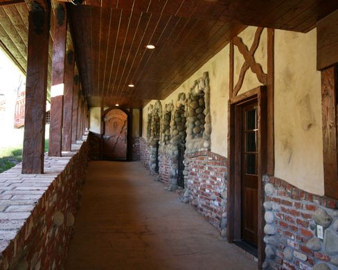 A long hallway with brick walls and wooden beams