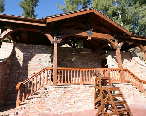 A brick building with a wooden railing and stairs