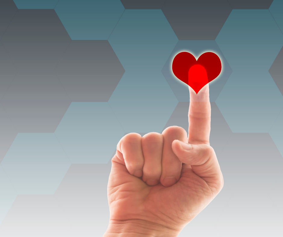 Hand pointing to a red heart icon on a digital health interface background