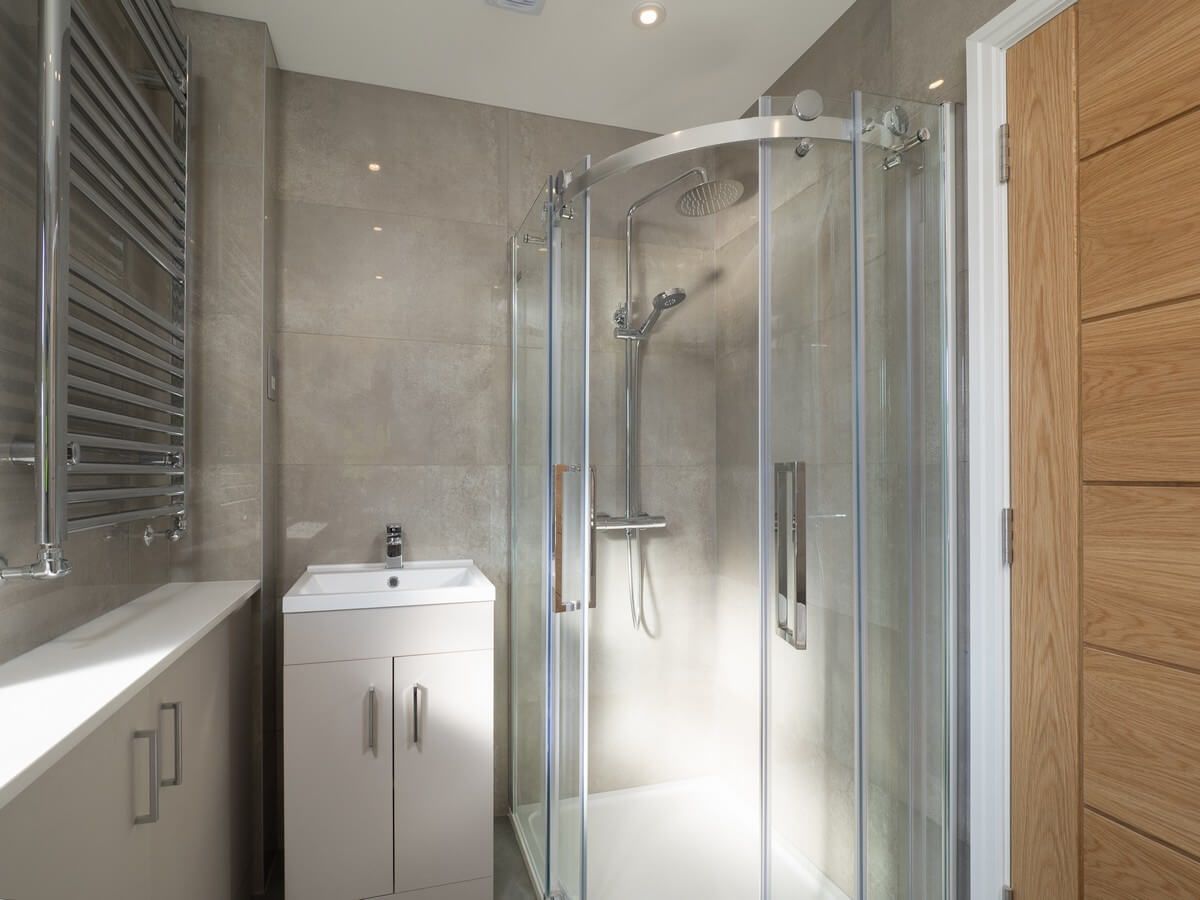 slim bathroom with a shower cabinet