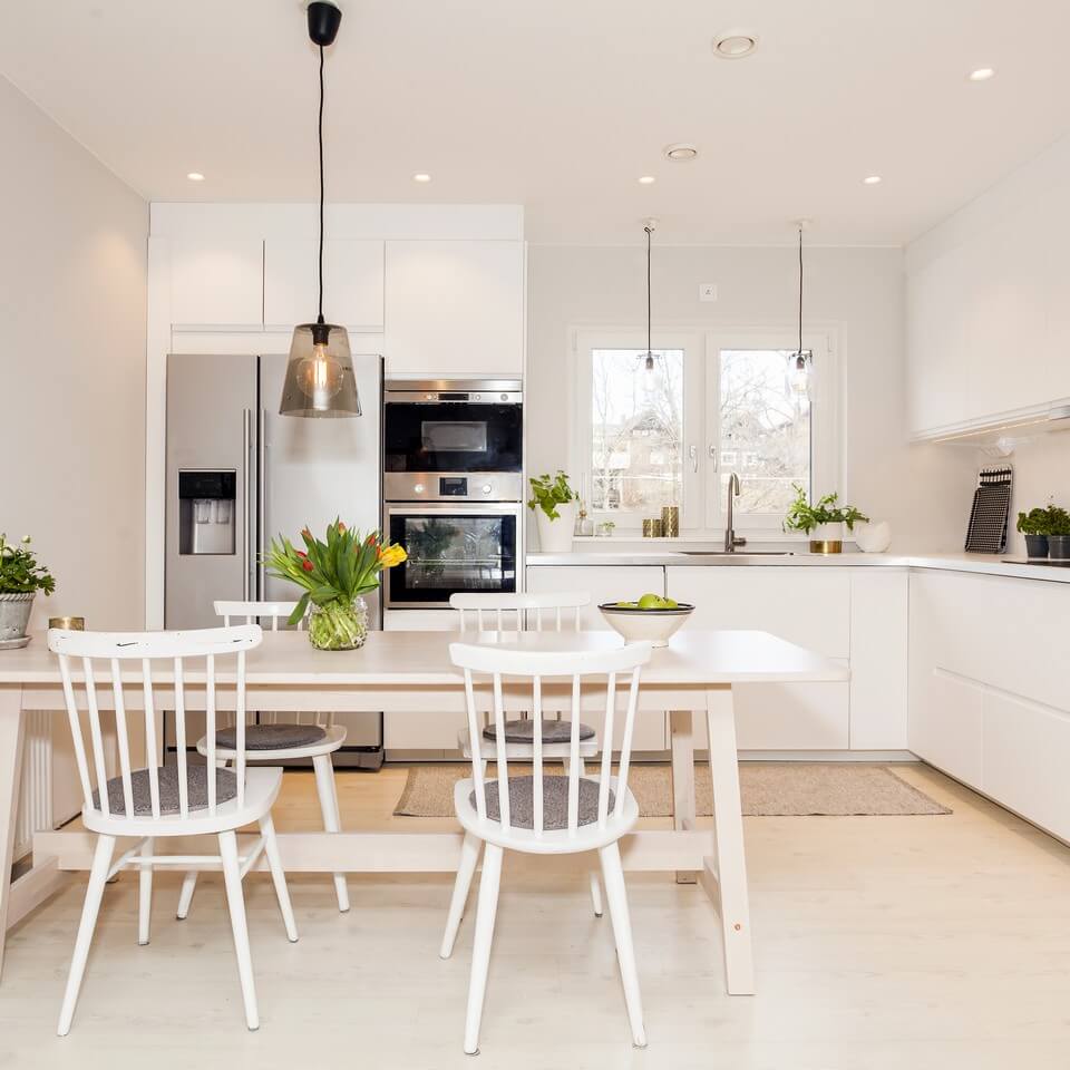 white kitchen, with chairs and table