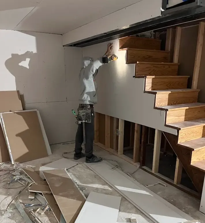 Professional contractor installing drywall panels during a residential renovation in Chester County, PA.