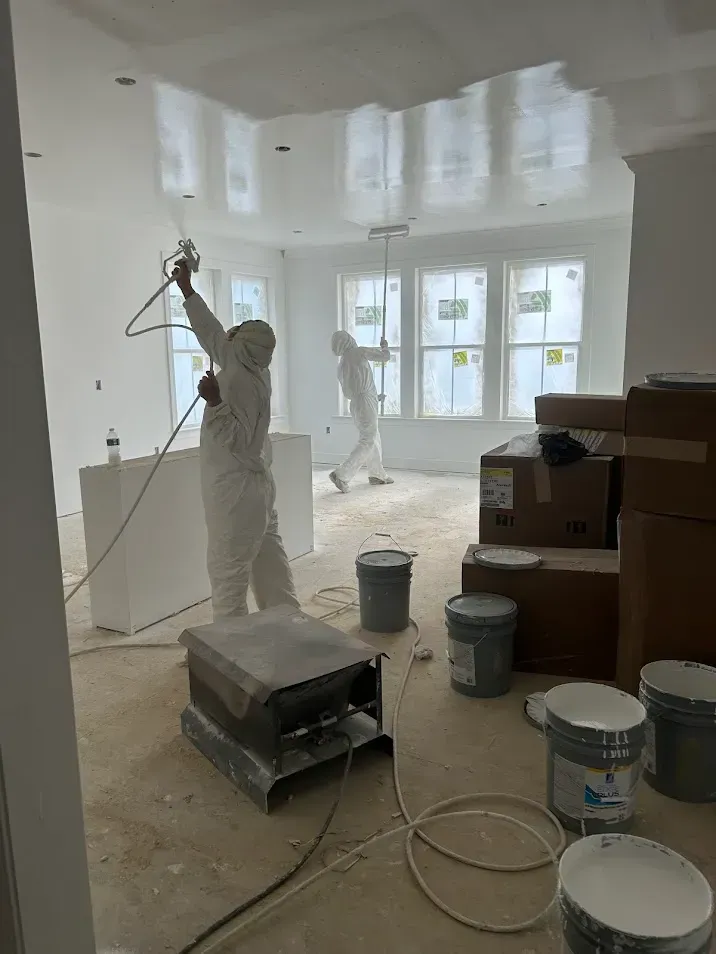 Lansdale PA interior painting –professional painters spraying and rolling white walls and ceiling by Oasis Painting & Drywall