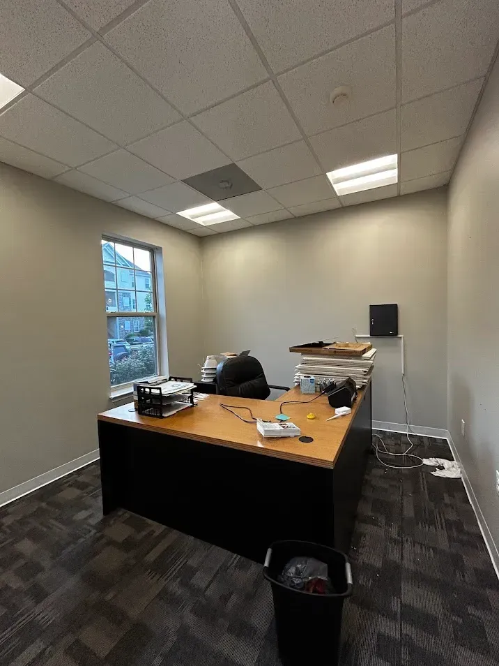 Lancaster PA office painting – neutral walls and ceiling with lights in empty office by Oasis Painting & Drywall.