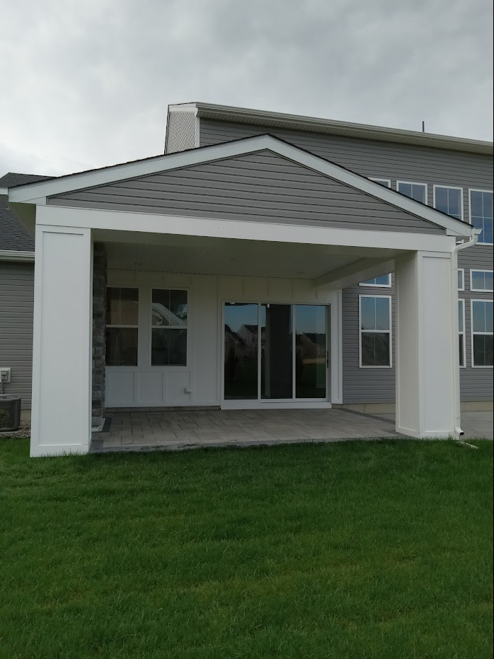 It's a house with a porch with columns freshly painted white and lots of windows.