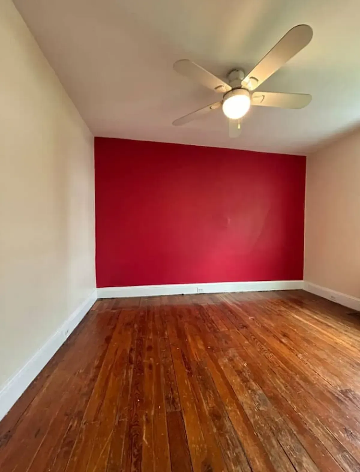 Philadelphia PA interior painting – red accent wall with cream walls and white ceiling by Oasis Painting & Drywall.