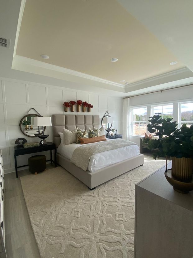 There is a large bed in the middle of the room and features freshly painted white walls in Lancaster county