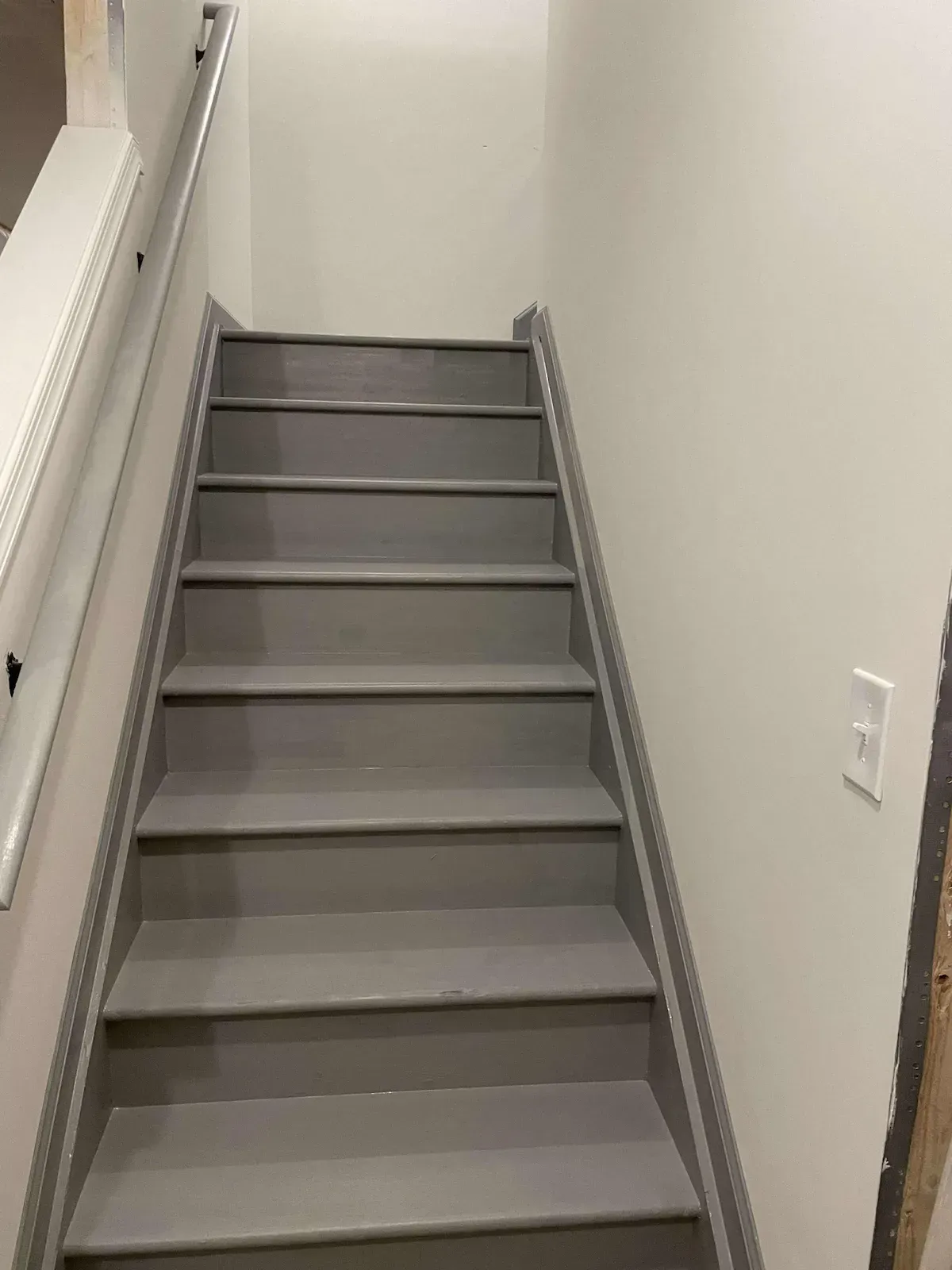 Doylestown PA interior painting – gray staircase with white wall and handrail by Oasis Painting & Drywall