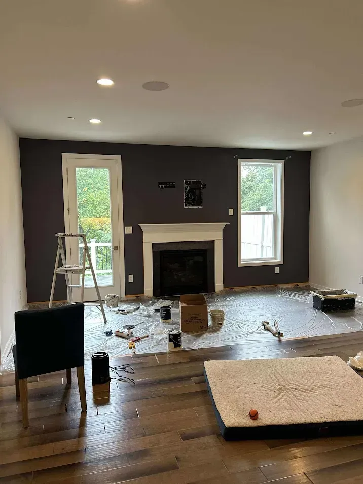 West Chester PA living room painting – one black wall with white walls by professional painters Oasis Painting & Drywall.
